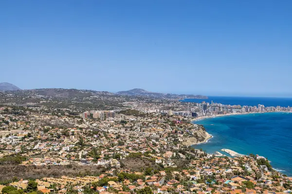 stock image Aerial drone photo of the beautiful coastal town of  Calp on Spains Mediterranean coast showing an aerial drone view of the coastal front from above on a sunny day in the summer time