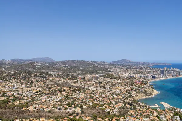 stock image Aerial drone photo of the beautiful coastal town of  Calp on Spains Mediterranean coast showing an aerial drone view of the coastal front from above on a sunny day in the summer time