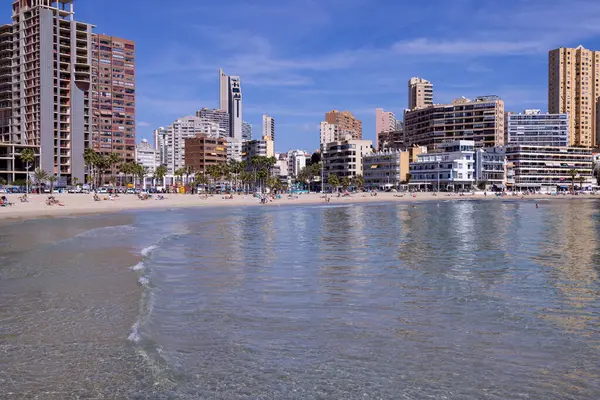 stock image Photo of the town of Benidorm in Spain in the summer time showing the beach known locally as Playa de Finestrat and hotels and apartments around the small sandy beach