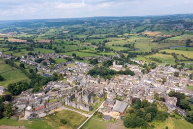 Aerial drone photo of the beautiful town of Middleham in Leyburn in North Yorkshire in the UK showing the British countryside town and the historic Middleham Castle on a sunny day in the summer time clipart