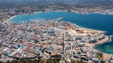 Aerial drone photo of a beach in the town of Sant Antoni de Portmany on the island of Ibiza in the Balearic Islands Spain showing the boating harbour and the beach known as Playa de San Antonio clipart