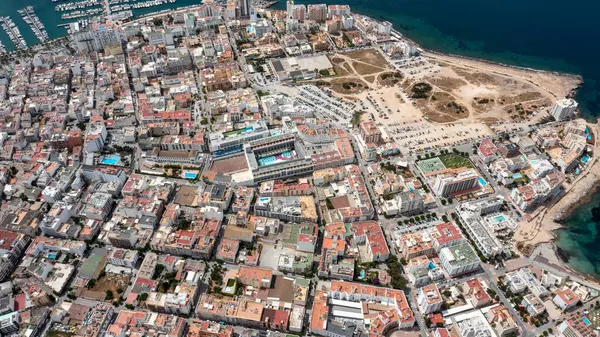 stock image Straight down aerial drone photo of the town of Sant Antoni de Portmany on the west coast of Ibiza one of Spains Balearic Islands, showing hotels, apartments and businesses on the village in summer