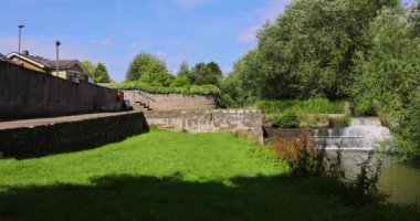 Kuzey Yorkshire, İngiltere 'de bir pazar kasabası olan Bedale' in yavaş çekim görüntüleri. Yazın güneşli bir günde Bedale Beck ve şelalesini gösteriyor.