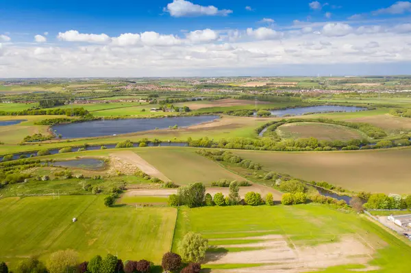 stock image Aerial country side photo of a beautiful spring time scenic view with blue sky and fluffy white clouds located in the village of Castleford in Wakefield West Yorkshire in the UK