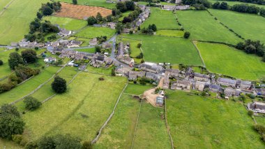 Aerial photo of the beautiful village of Thoralby in the Richmondshire district of North Yorkshire in the UK, showing the small British village and surrounding green fields in the summer time