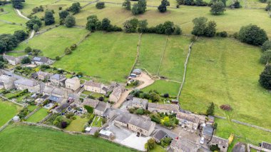 Aerial photo of the beautiful village of Thoralby in the Richmondshire district of North Yorkshire in the UK, showing the small British village and surrounding green fields in the summer time