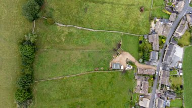 Aerial photo of the beautiful village of Thoralby in the Richmondshire district of North Yorkshire in the UK, showing the small British village and surrounding green fields in the summer time clipart