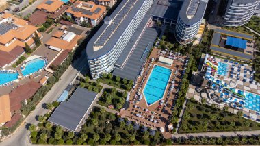 Aerial drone photo of the beautiful town of Alanya a resort town on Turkeys central Mediterranean coast showing a hotel and vacation holiday resort from above in the summer time. clipart