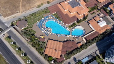 Aerial drone photo of the beautiful town of Alanya a resort town on Turkeys central Mediterranean coast showing a hotel and vacation holiday resort from above in the summer time. clipart