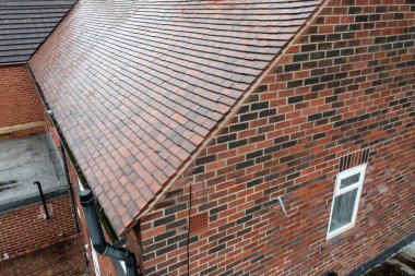 İngiltere 'deki tipik bir İngiliz teras evinin havadan çekilmiş fotoğrafı. Kışın evin kirli çatısındaki çatı ve fayansları gösteriyor.