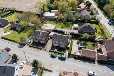 Aerial drone photo of the village of West Cowick in Goole in the East Riding of Yorkshire England showing the streets and houses and homes in the British village in the summer time clipart