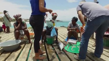 Cape Verde, Sal, 17 Mayıs 2018: Balıkçı eşleriyle Cape Verde 'deki ünlü rıhtımın rıhtımda balık satan balıkçılarla çekilmiş görüntüleri, Sal Cape Verde Cabo Verde' deki Santa Maria plajında çekildi.