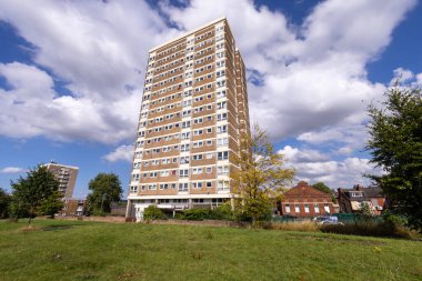 Photo of a block of council owned flats and apartments located in the district of Armley in the west of Leeds, West Yorkshire, England showing the high rise block on a sunny summers day clipart