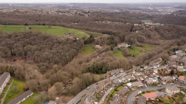 Aerial drone photo of the Village of Netherton near Huddersfield, in the Kirklees metropolitan borough of West Yorkshire, England showing the residential houses in the winter time clipart