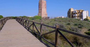 Mijas İspanya 'nın Sitio de Calahonda kasabasındaki eski bir kulenin görüntüsü sıcak bir günde okyanusun kenarında La Torre de Los Ladrones olarak bilinen terk edilmiş kuleyi gösteriyor.