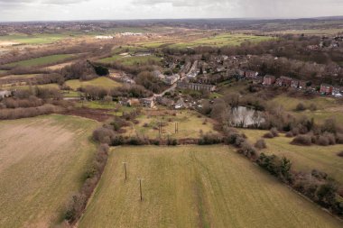 Aerial drone photo of the town of Thornhill Edgein Dewsbury West Yorkshire in the UK showing the British town from above and rows of traditional terrace houses in the winter time clipart