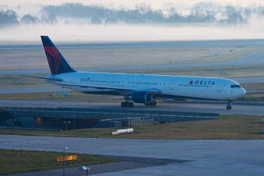 Munich, Germany - March 30, 2014: Delta Airlines passenger plane at airport. Schedule flight travel. Aviation and aircraft. Air transport. Global international transportation. Fly and flying. clipart