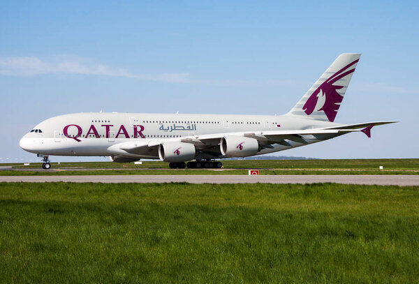 Paris, France - April 19, 2015: Qatar Airways passenger plane at airport. Schedule air travel. Aviation and aircraft. Air transport. Global international transportation. Fly and flying.