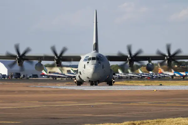 Stock image Untitled military transport plane at air base. Airport and airfield. Air force and army flight operation. Aviation and aircraft. Air lift. Military industry. Fly and flying. Commercial theme.