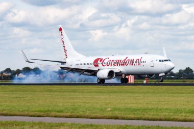 Amsterdam, Netherlands - August 14, 2014: Corendon Airlines passenger plane at airport. Schedule flight travel. Aviation and aircraft. Air transport. Global international transportation. Fly and flying. clipart