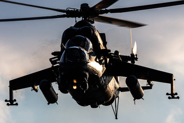 Szolnok, Hungary - August 17, 2022: Hungarian Air Force Mil Mi-24 Hind military attack helicopter. Flight operation. Aviation industry and rotorcraft. Transport and airlift. Fly and flying.