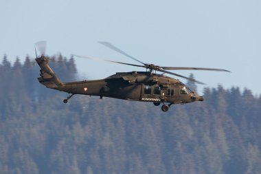 Zeltweg, Austria - September 3, 2022: Austrian Air Force Sikorsky S-70 Blackhawk. Military transport helicopter at air base. Aviation and rotorcraft. Transport and airlift. Military industry. Fly and flying. clipart