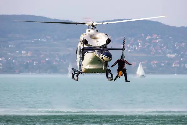 stock image Zamardi, Hungary - September 16, 2020: Hungarian air police MD900 Explorer helicopter flying operation. SAR Search and rescue mission with rope.