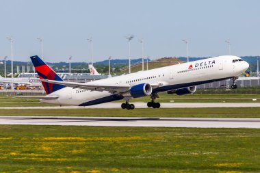 Munich, Germany - May 19, 2013: Delta Airlines passenger plane at airport. Schedule flight travel. Aviation and aircraft. Air transport. Global international transportation. Fly and flying. clipart