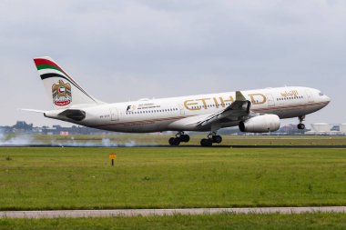 Amsterdam, Netherlands - July 3, 2017: Etihad Airways passenger plane at airport. Schedule flight travel. Aviation and aircraft. Air transport. Global international transportation. Fly and flying. clipart