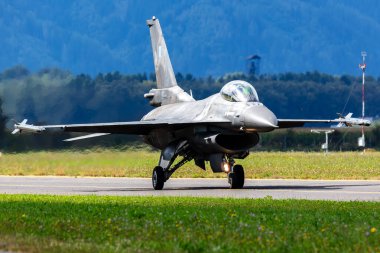 Zeltweg, Austria - September 7, 2024: Hellenic Air Force Lockheed Martin F-16 Fighting Falcon fighter jet plane at air base. Aircraft flying maneuver. Flight operation. Military aviation. Air defense. clipart