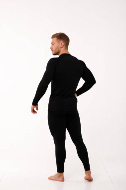 Athletic man in thermal underwear on a white background. Thermal underwear for men