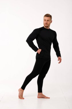 Athletic man in thermal underwear on a white background. Thermal underwear for men