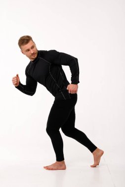 Athletic man in thermal underwear on a white background. Thermal underwear for men