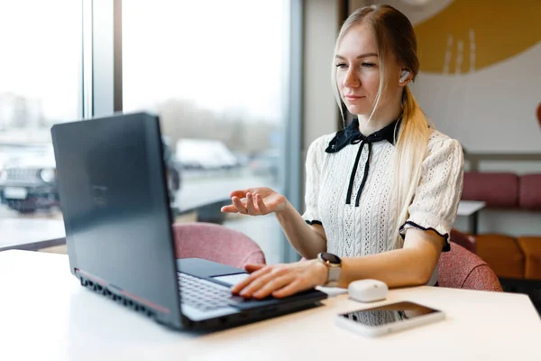 stock image A girl, Yulia, studies and works in a coffee shop on a computer.