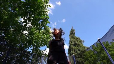Teen Child Jumping in Trampoline