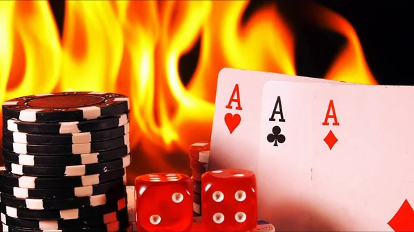 Gambling Poker Cards Money Chips and Red Dices on Fire  Photo