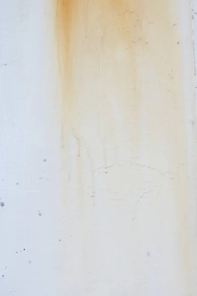 Vertical image of brown rust stain on plain white background. High quality photo