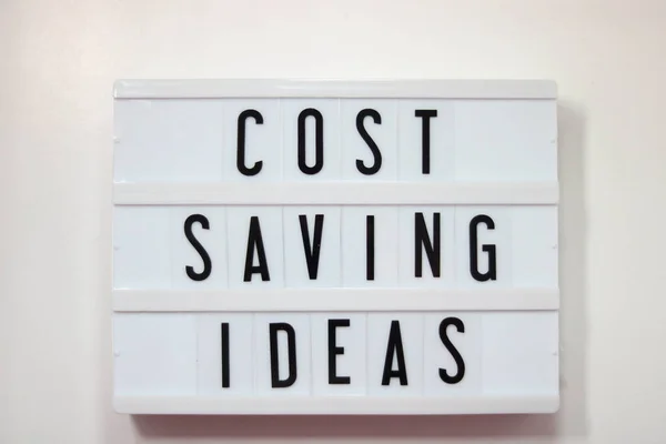 Electric Lightbox saying Cost Saving Ideas against plain white background. High quality photo