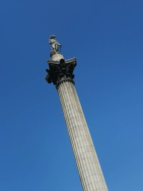 14 Mayıs 2023: Londra, İngiltere - Nelsons sütunu derin mavi gökyüzüne karşı bir açıyla görülüyor. Yüksek kaliteli portre fotoğrafı.