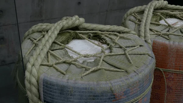 Close up image of builders cylindrical containers bound with string and rope. High quality photo