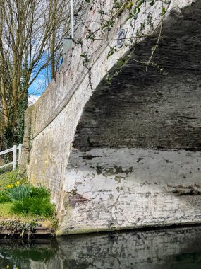 15 March 2025 - Middlesex, England: Bridge over the Grand Union Canal reflected in water. High quality photo clipart