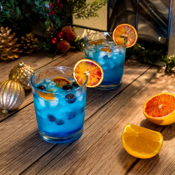 Vibrant Glowing Ocean Breeze Blue Cocktails Garnished Blueberries Dried Orange — Stock Photo, Image