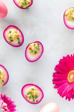 An Easter arrangement of homemade beet juice soaked devilled eggs and ornaments.