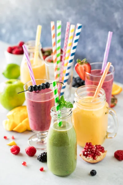 stock image Healthy fresh fruit smoothies with colourful straws, ready for drinking.