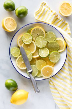 Kesmek için bir tabak taze dilimlenmiş limon ve limon.. 