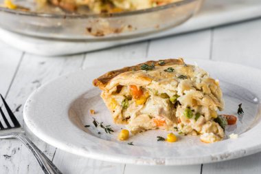 A slice of delicious homemade turkey pot pie, ready for eating. 