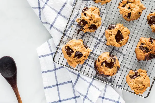 Ev yapımı fıstık ezmesi ve çikolata parçalı kurabiyelerin soğutma rafında en üstten görünüşü.