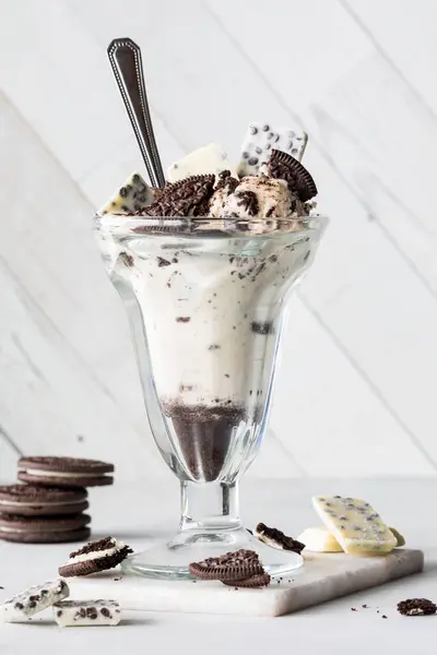 Chocolate cookies and cream ice cream dessert, garnished with cookie and chocolate pieces.