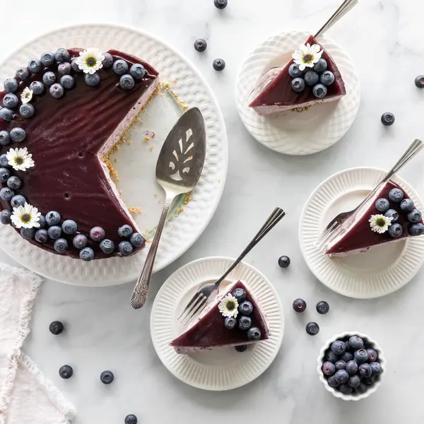 stock image Above view of slices of blueberry cheesecake with the remaining cake beside.