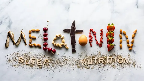 stock image Above view of the word melatonin made from foods that contain the important sleep nutrient.